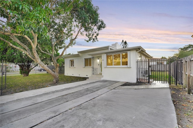 single story home with a front yard, stucco siding, and fence