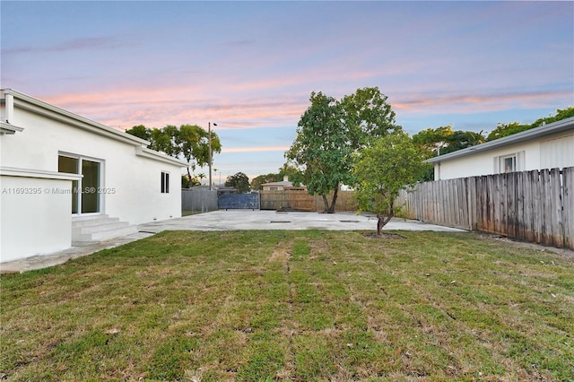 yard at dusk with a patio