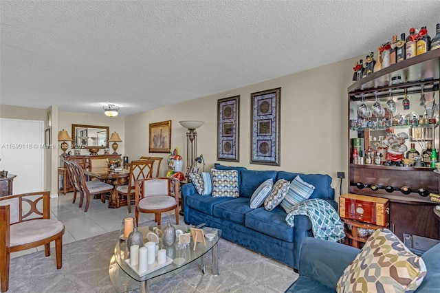 living room with light tile patterned floors and a textured ceiling