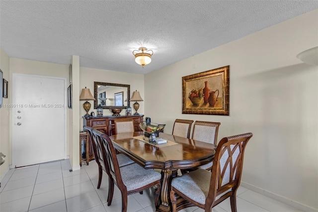 tiled dining room with a textured ceiling