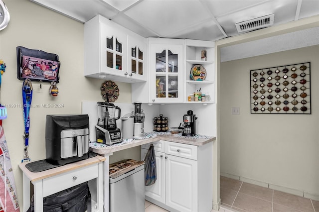 kitchen featuring white cabinets and light tile patterned floors