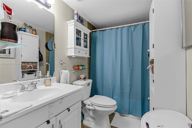 bathroom featuring tile patterned flooring, vanity, toilet, and walk in shower