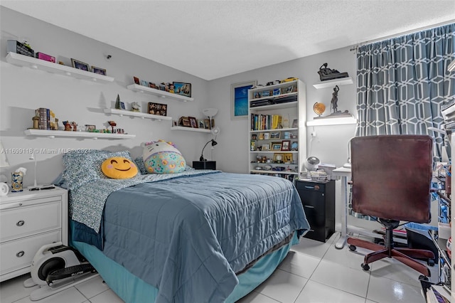 bedroom with light tile patterned floors and a textured ceiling