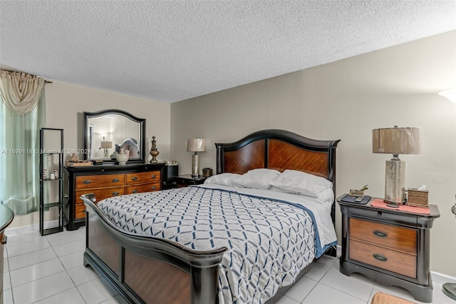 bedroom with a textured ceiling and light tile patterned flooring