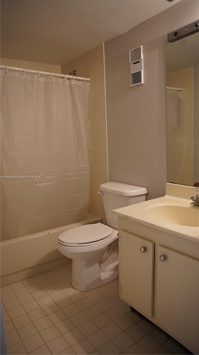 bathroom featuring tile patterned floors, curtained shower, vanity, and toilet