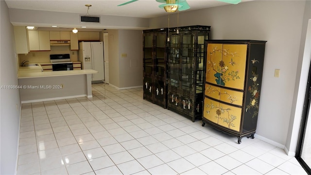 kitchen with sink, light tile patterned floors, and white appliances