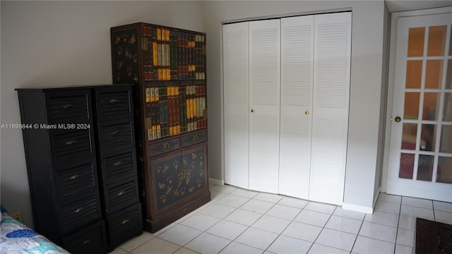 tiled bedroom featuring a closet