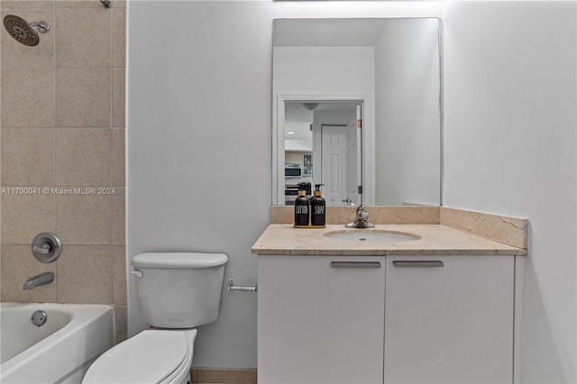 full bathroom with vanity, toilet, and tiled shower / bath