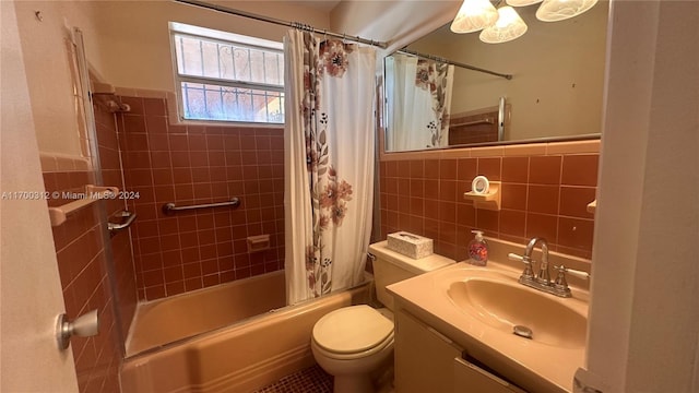 full bathroom featuring shower / tub combo with curtain, vanity, tile walls, and toilet