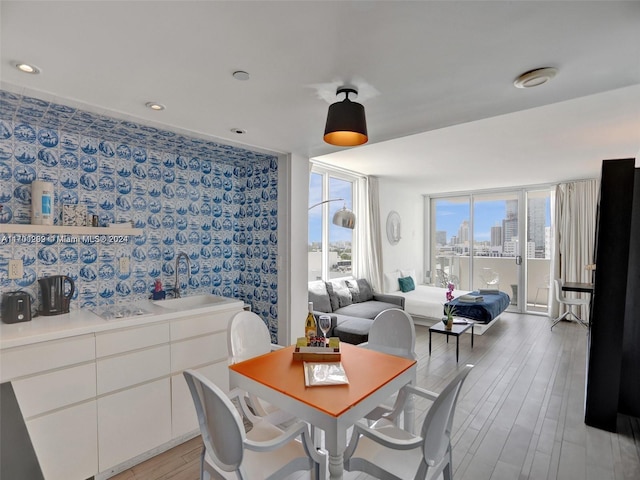 dining room with sink and light hardwood / wood-style flooring