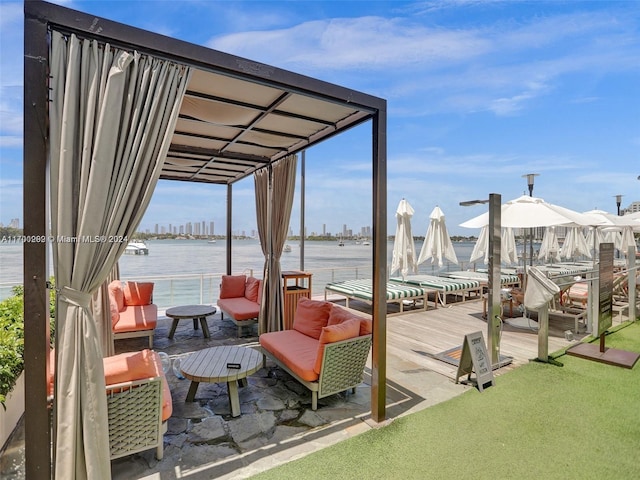 wooden deck featuring outdoor lounge area and a water view