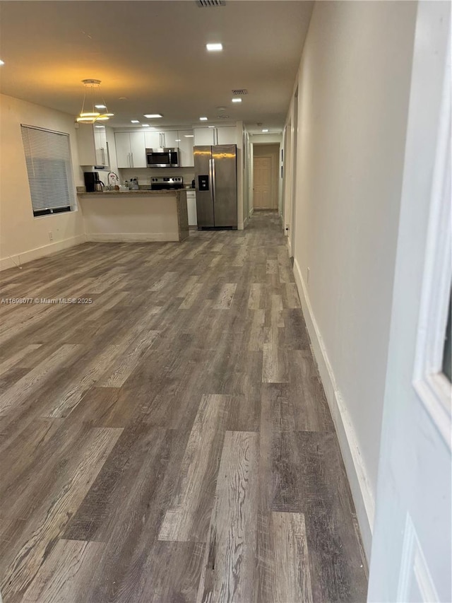 unfurnished living room with dark hardwood / wood-style floors