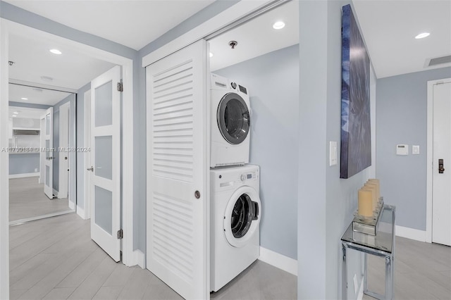 laundry area with stacked washer and clothes dryer