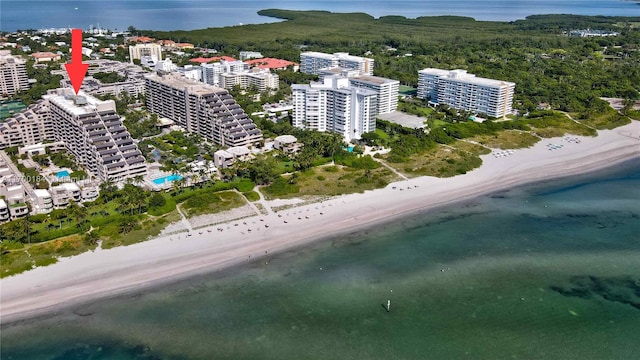 bird's eye view featuring a view of the beach and a water view