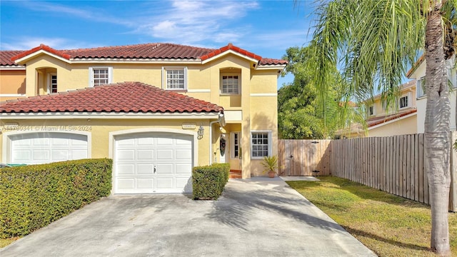 mediterranean / spanish house with a garage