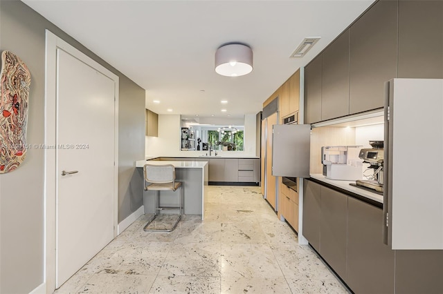 kitchen with a kitchen breakfast bar and sink