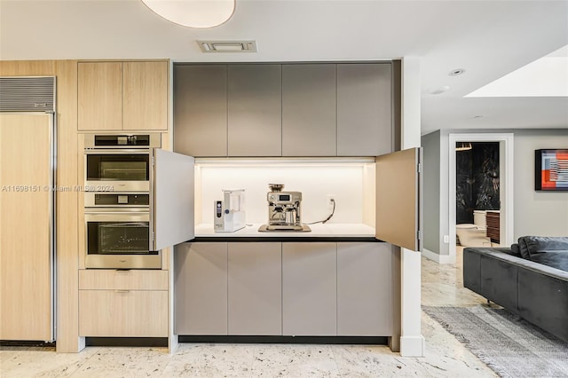 kitchen featuring light brown cabinetry and stainless steel appliances