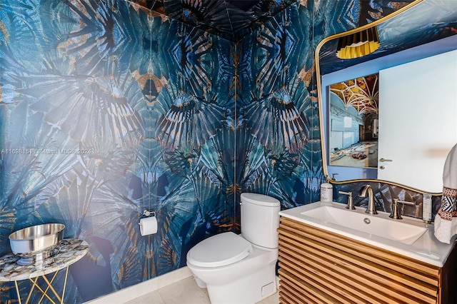 bathroom with tile patterned flooring, vanity, and toilet