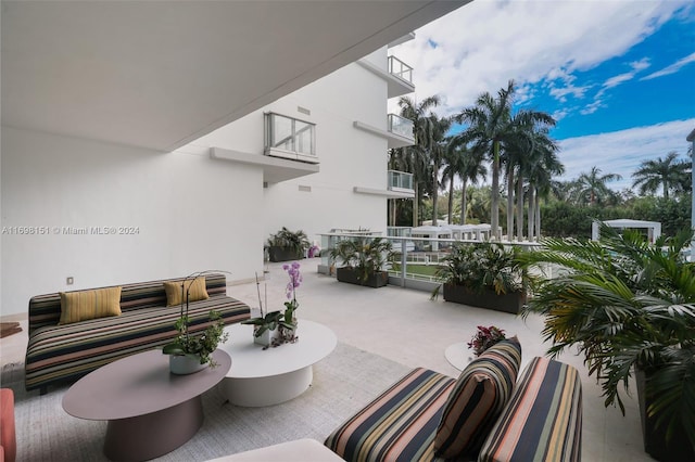 view of patio with outdoor lounge area and a balcony