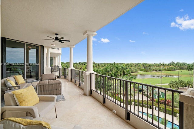 balcony with a water view and ceiling fan