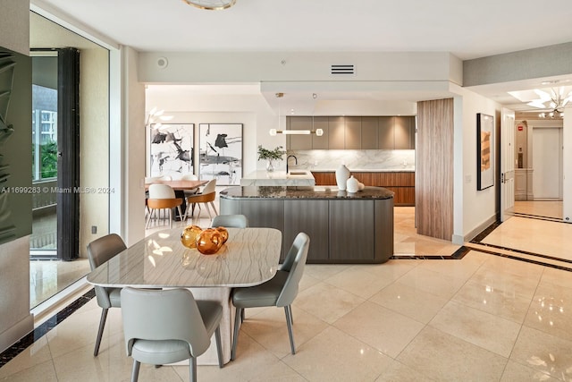 dining space with sink and an inviting chandelier