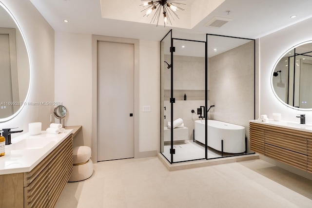 bathroom featuring vanity, separate shower and tub, and an inviting chandelier