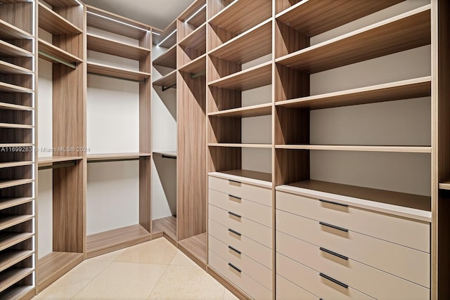 spacious closet with light tile patterned flooring