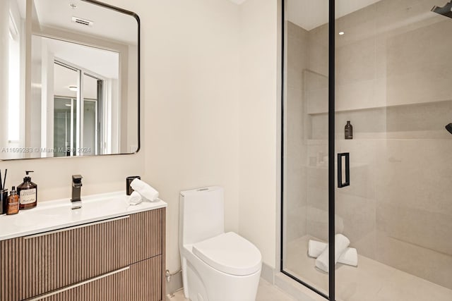 bathroom with tile patterned floors, vanity, toilet, and a shower with door