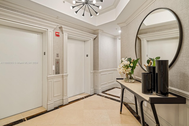 hallway with elevator, a raised ceiling, a chandelier, light tile patterned floors, and ornamental molding