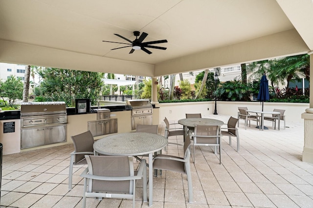 view of patio / terrace with a grill, ceiling fan, and exterior kitchen