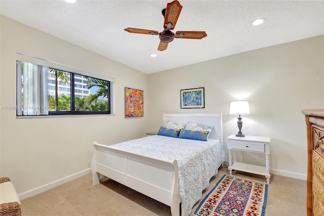 carpeted bedroom with a textured ceiling and ceiling fan