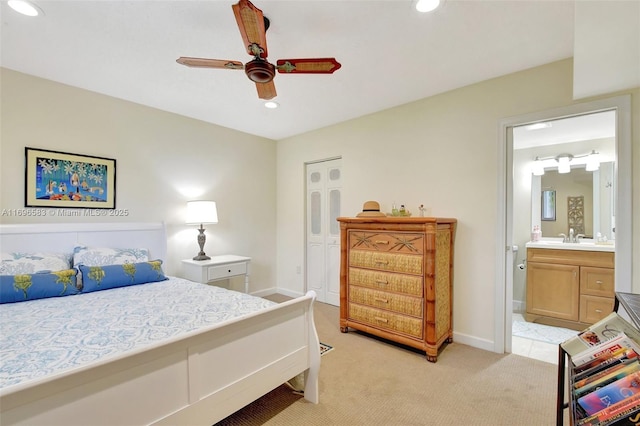 carpeted bedroom featuring ensuite bathroom and ceiling fan