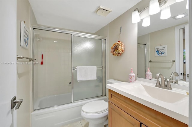 full bathroom with toilet, bath / shower combo with glass door, tile patterned floors, and vanity