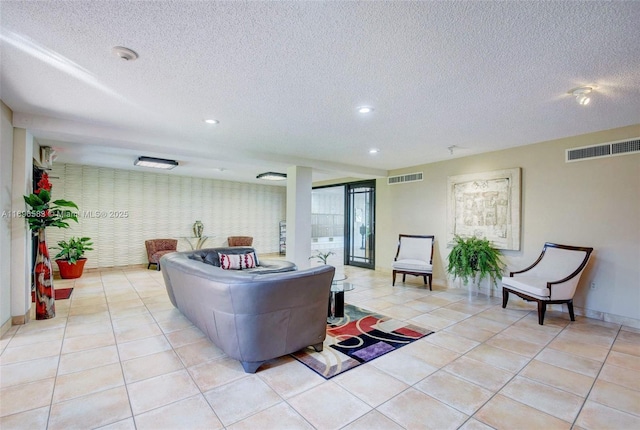 living room with light tile patterned floors and a textured ceiling