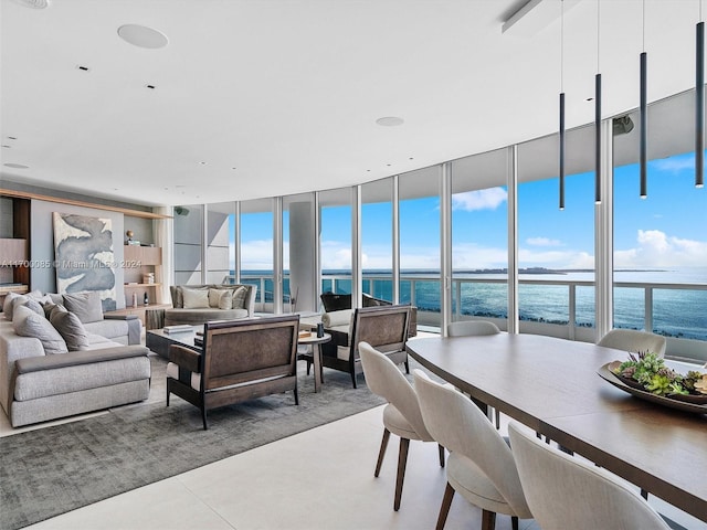 living room featuring floor to ceiling windows and a water view