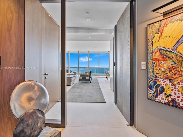 corridor with a water view and floor to ceiling windows