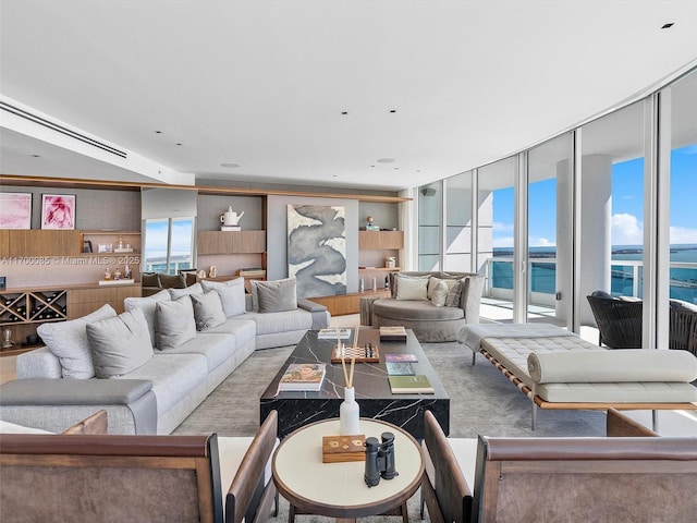 living room with a water view and a wall of windows