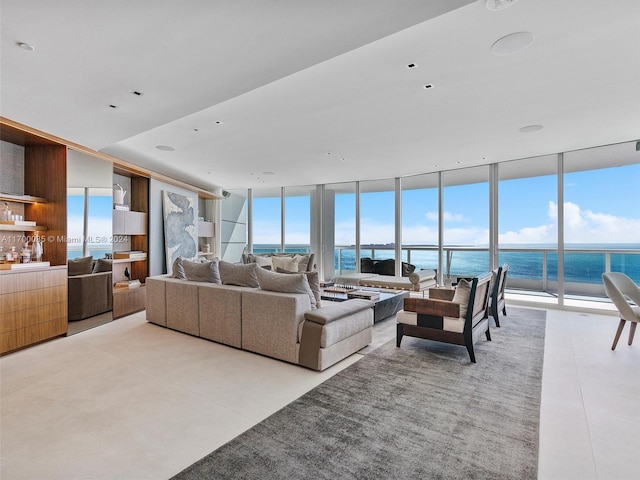 tiled living room featuring a wall of windows and a water view