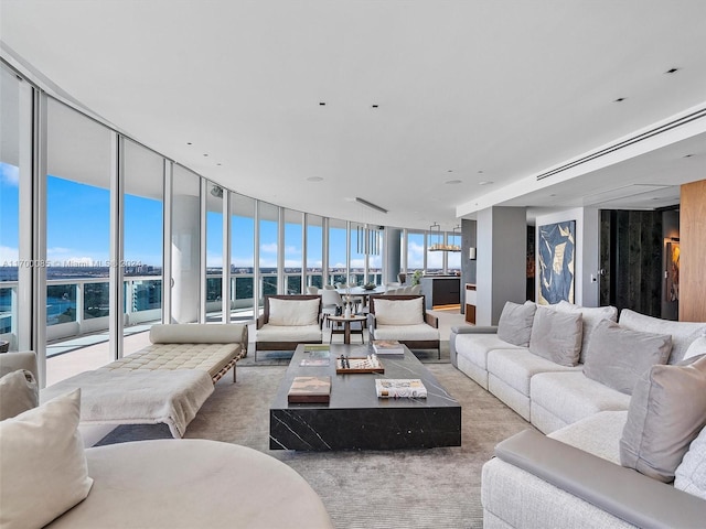 living room with light carpet and floor to ceiling windows