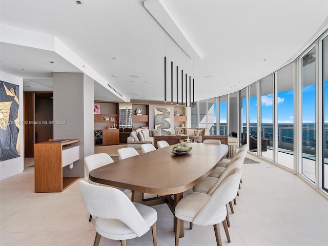 dining room featuring a wall of windows and a wealth of natural light