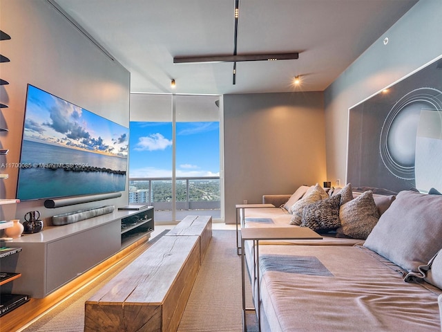 bedroom with carpet floors, expansive windows, and track lighting