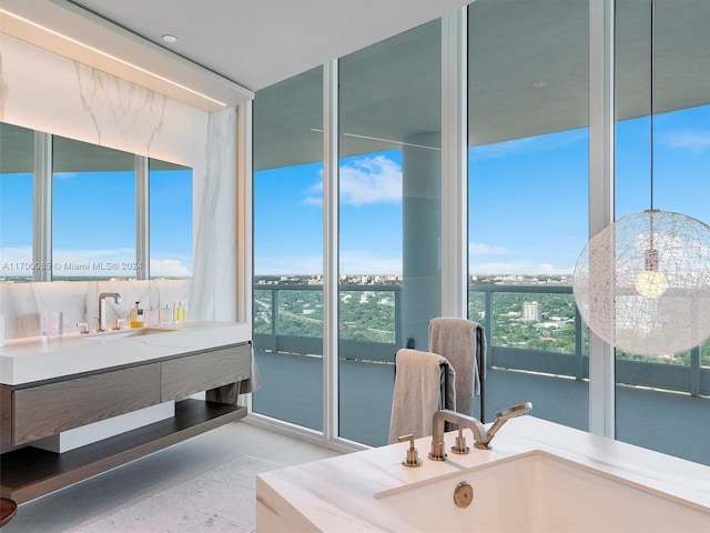 bathroom with vanity and floor to ceiling windows