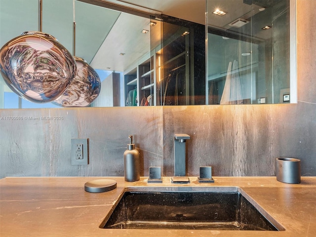 room details with backsplash, a sink, and visible vents