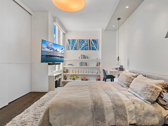 bedroom with dark hardwood / wood-style flooring