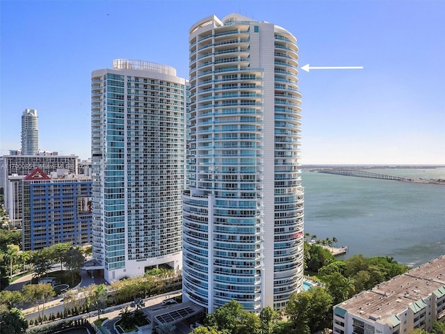 view of building exterior with a city view and a water view