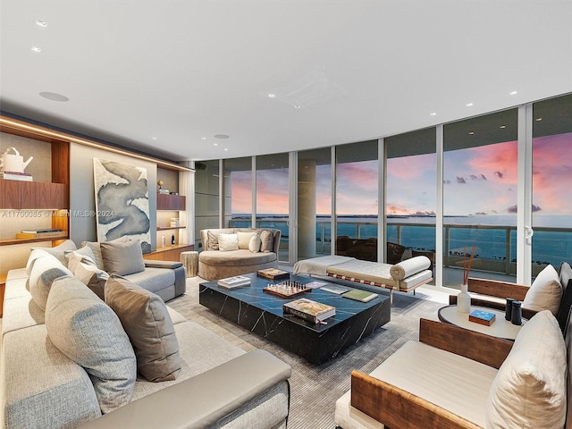 living room with a wall of windows and a water view