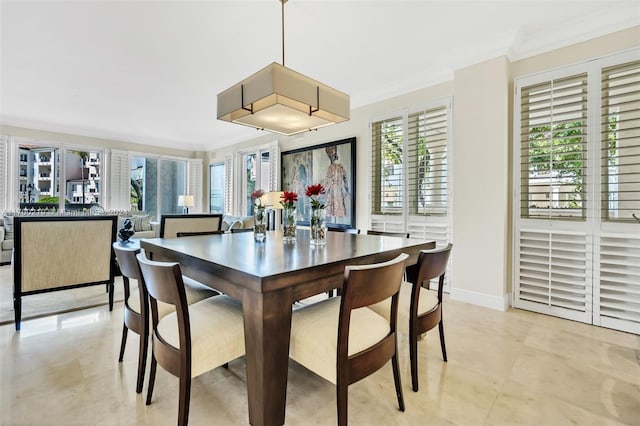 dining room featuring crown molding