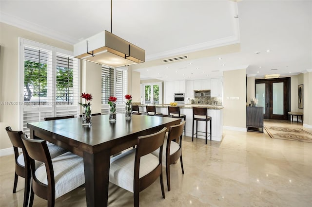 dining area with ornamental molding