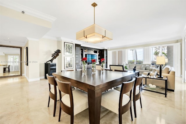 dining space with ornamental molding and a healthy amount of sunlight