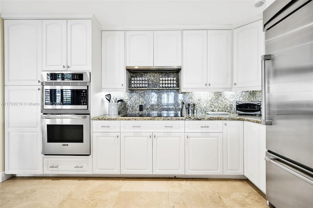 kitchen with white cabinetry, stone counters, and stainless steel appliances